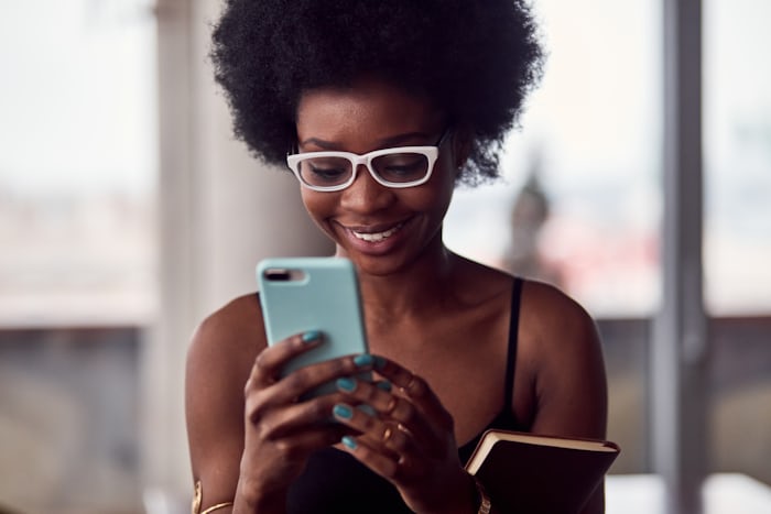 Checking the family budget app on a phone
